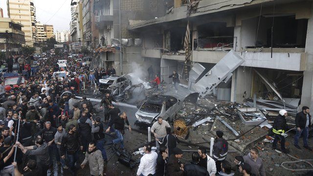 Lebanese citizens gather at the site of a car bomb explosion in Beirut