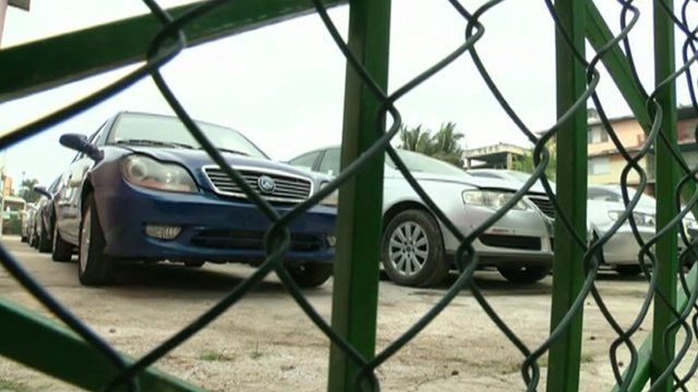Cars behind wire fence