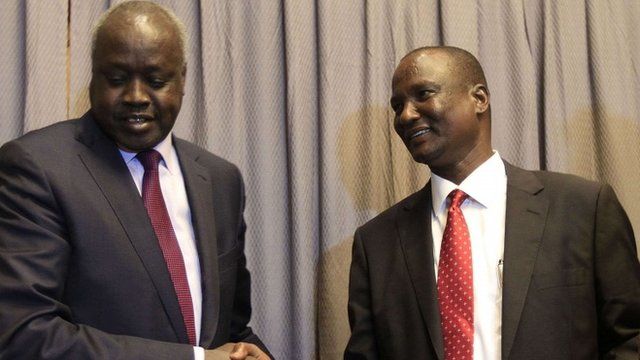 South Sudanese rebel delegation chief Taban Deng (R) shakes hands with South Sudanese leader of the government's delegation Nial Deng Nial