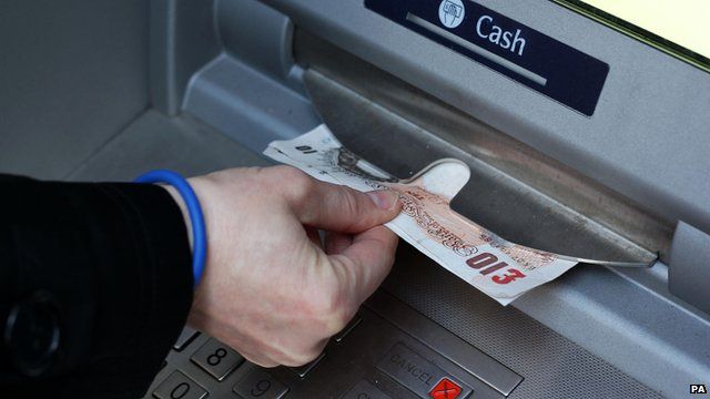 Person taking money out of a cash machine