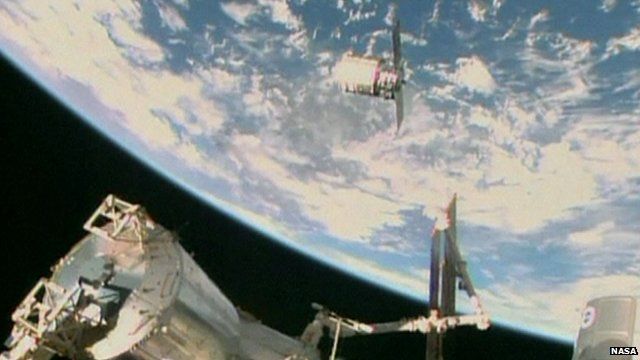Nasa TV image shows the Orbital Sciences Corporation's unmanned Cygnus cargo ship being captured by the Canadarm after arriving at the International Space Station
