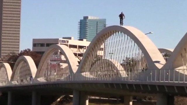 BMX rider on arches of bridge