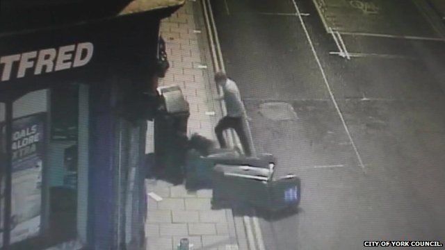 CCTV still shows man knocking over wheelie bins on a York street