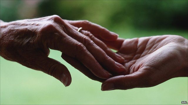 Two people touch hands