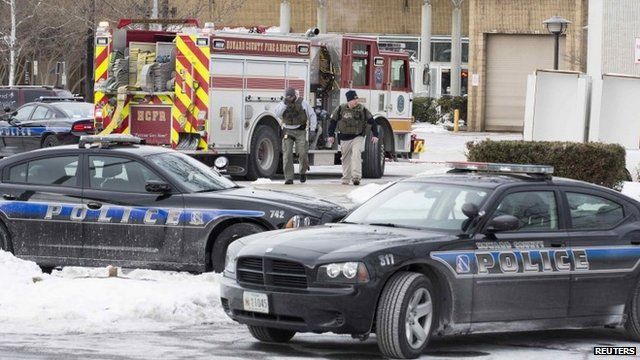 Armed police leave an entrance of a Columbia Mall after a shooting took place