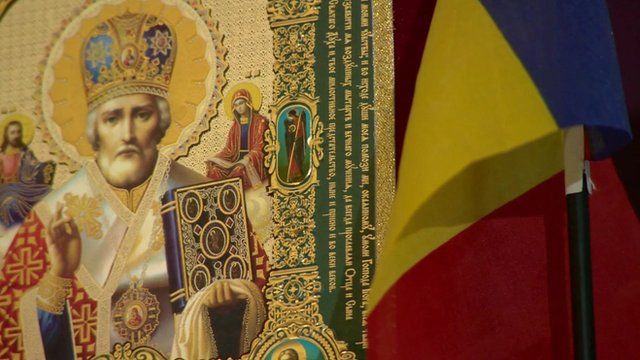 Religious icon and Romanian flag
