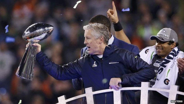 Seattle Seahawks head coach Pete Carroll holds up the Vince Lombardi Trophy next to quarterback Russell Wilson