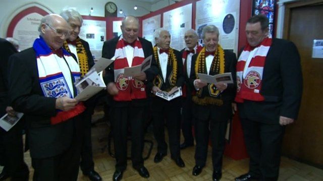 Choristers wearing football scarves