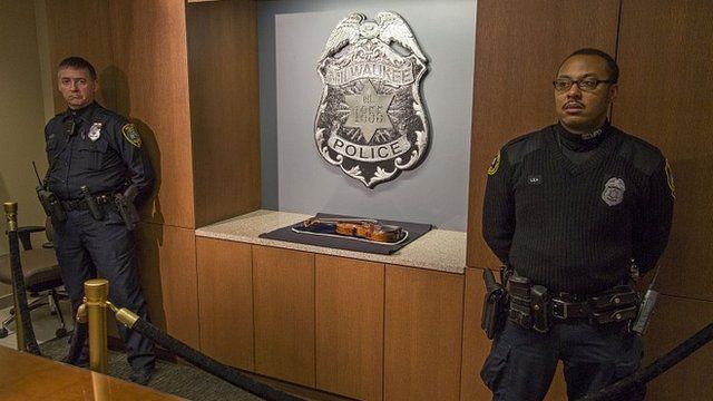 Wisconsin police stand guard over the recovered Stradivarius violin. 6 Feb 2014