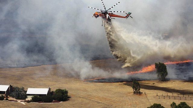 A water bomber in Victoria's Grampians region works to extinguish a large fire