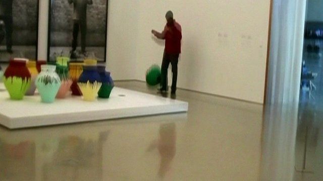 The vase falling to the ground