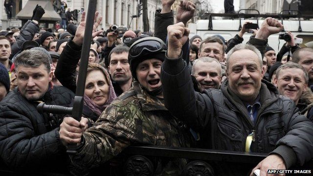 People celebrate outside the Parliament in Kiev
