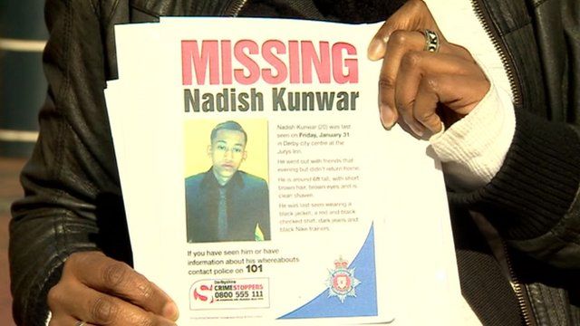Friend holds poster of missing Nadish Kunwar