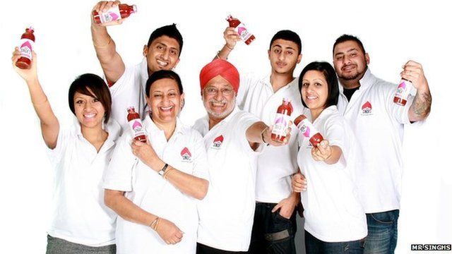 The Sahota family hold up bottles of sauce