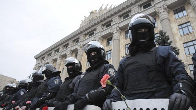 Riot police stand guard in front of regional government building as pro-Russian demonstrators take part in a rally in Kharkiv