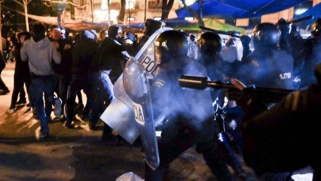 Demonstrators clash with anti-riot police officers at the end of a march against austerity in Madrid in Spain