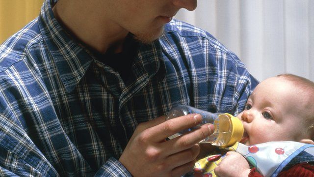 Father feeding a baby