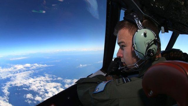 A flight lietenant looks out of the cockpit of an RAAF aircraft