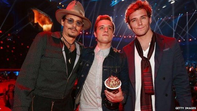 Johnny Depp poses with Josh Hutcherson and Sam Claflin