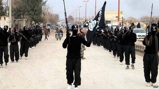 Undated image posted on a militant website shows rebel fighters from the Islamic State of Iraq and the Levant (Isis) marching in Raqqa, Syria