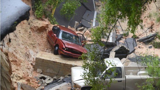 Two vehicles which fell 40ft when a scenic highway collapsed in Pensacola, Florida