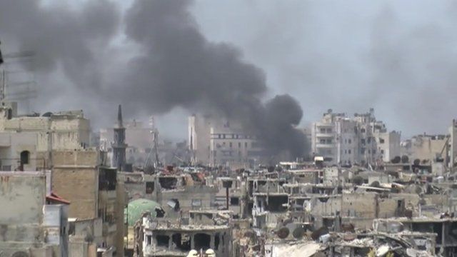Homs skyline with smoke coming from a building