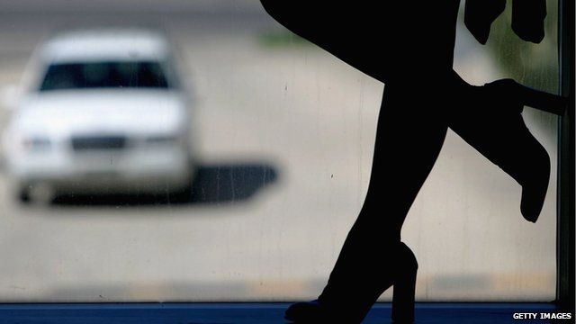Silhouette of a prostitute in a window