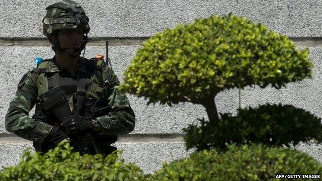 A Thai soldier stands guard as anti-government protest leaders meet with army chief General Prayut Chan-O-Cha