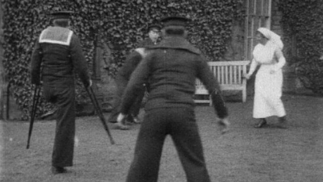 Matron plays football with sailors