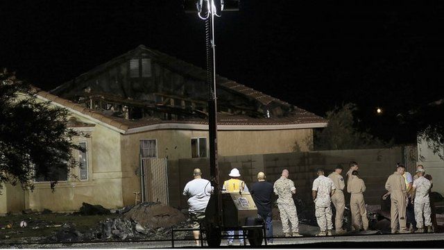 Investigators inspect the scene of a U.S. military jet crash in Imperial, California June 4, 2014