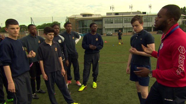 Pupils receiving football coaching