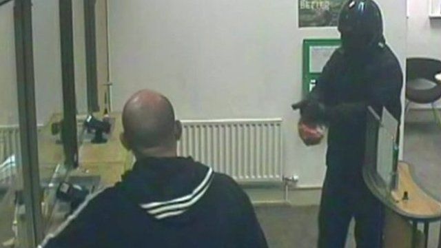 Still from CCTV as robber approaches bank counter