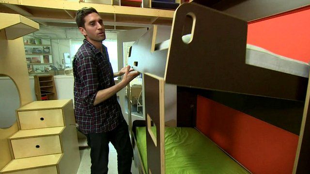 Juan Hernandez lowers a fold-away bunk bed