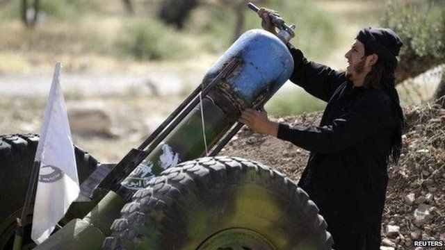 A Free Syrian Army fighter loading a weapon