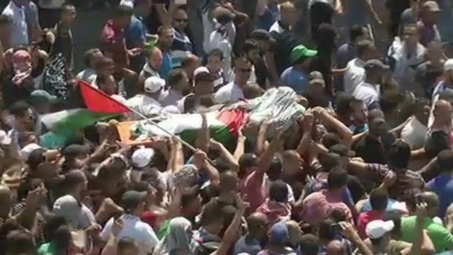 Mohammed Abu Khdair's body is carried through the streets