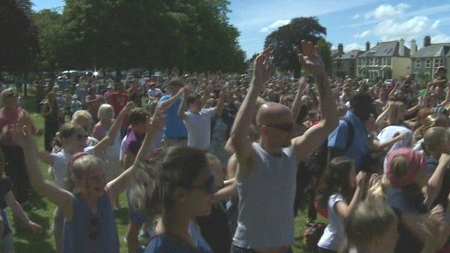 Volunteers do the Gangnam Style dance