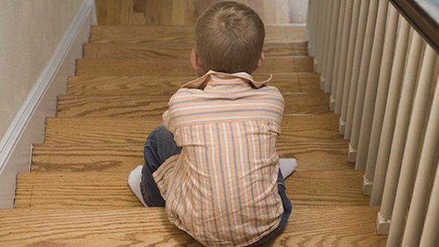 A child sitting on stairs
