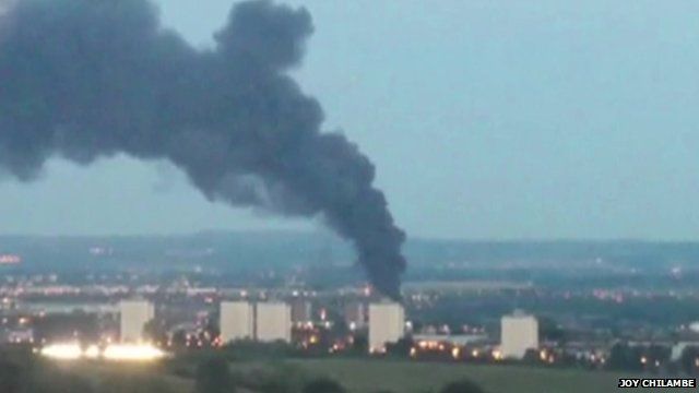 Mobile phone image of smoke rising near flats