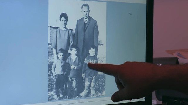 Petros Souppouris points at a photograph of the family he lost in a massacre
