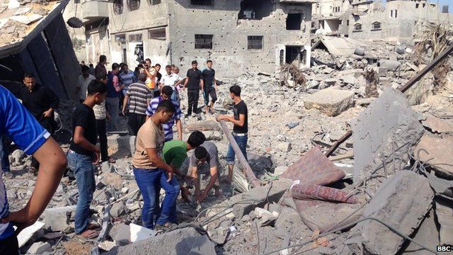 Residents in Shujaiya pick through the rubble (26 July 2014)