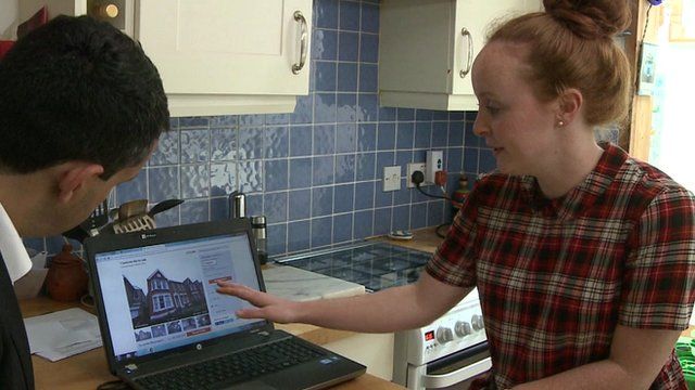 woman looks at property on laptop computer