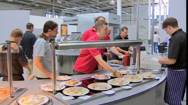 Workers queue for lunch at a factory canteen in Newport