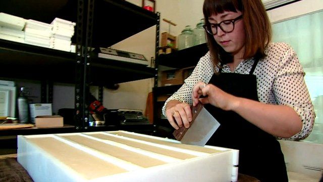 A woman making soap in her apartment