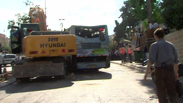 Digger and bus next to one another
