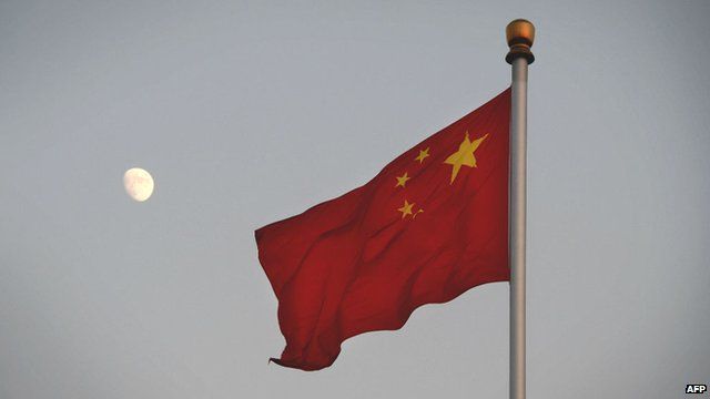 Chinese flag with the moon in the background