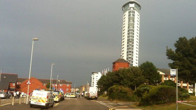 Police vehicles outside the Meridian Tower in Swansea Marina