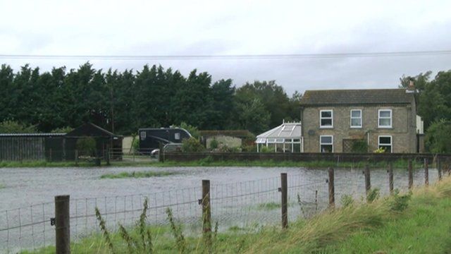 Fenland house surrounded by floodwater