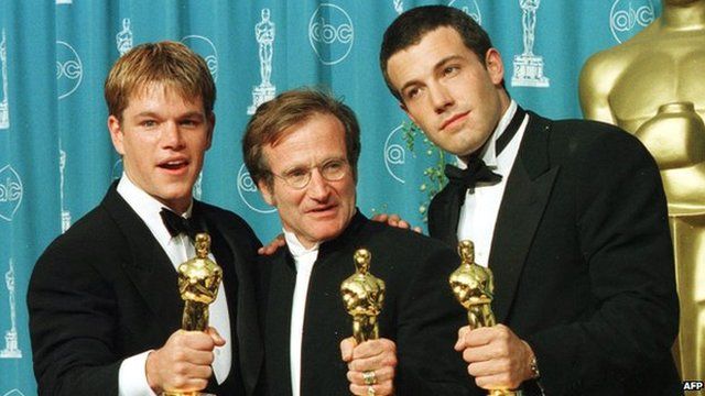 Williams with his Oscar, flanked by co-stars Matt Damon and Ben Affleck