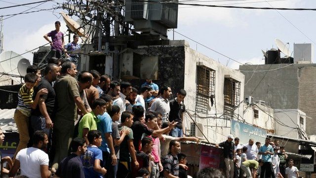 Palestinians watch as militants execute people suspected of collaborating with Israel