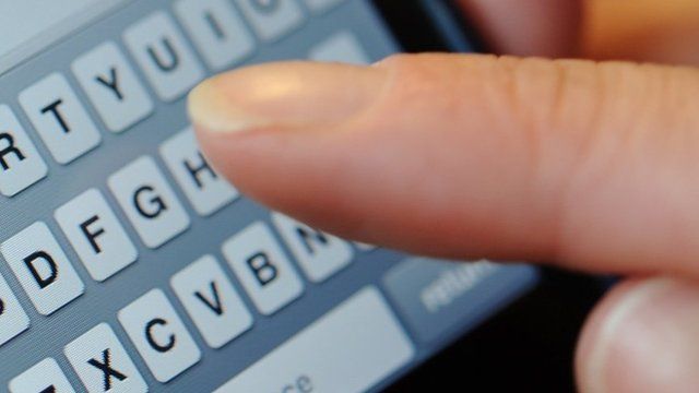 Person typing a text message on a phone